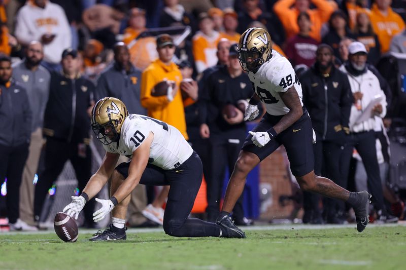 Nov 25, 2023; Knoxville, Tennessee, USA; Vanderbilt Commodores linebacker Langston Patterson (10) recovers a fumble against the Tennessee Volunteers during the second half at Neyland Stadium. Mandatory Credit: Randy Sartin-USA TODAY Sports