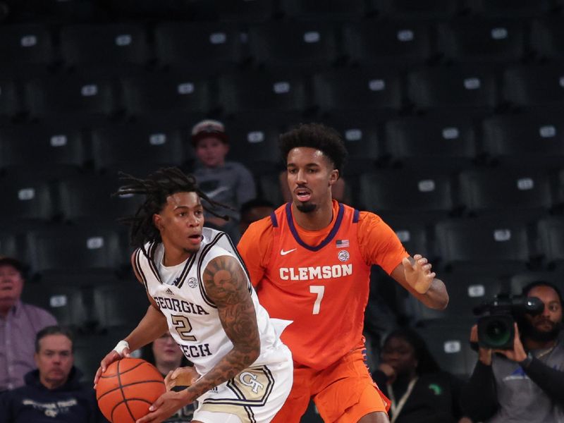 Jan 14, 2025; Atlanta, Georgia, USA; Clemson Tigers forward Chauncey Wiggins (7) plays defense against Georgia Tech Yellow Jackets guard Javian McCollum (2) during the second half at McCamish Pavilion. Mandatory Credit: Jordan Godfree-Imagn Images