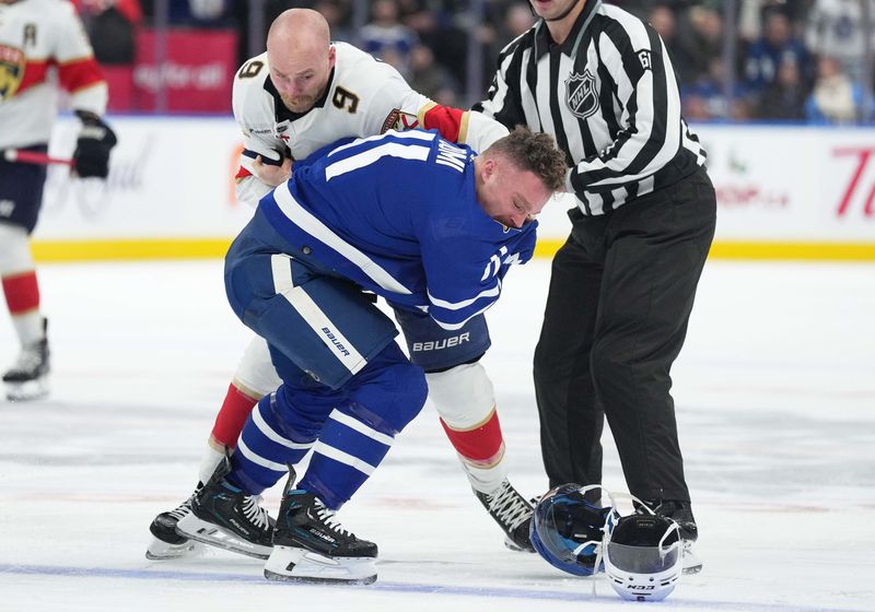 Nov 28, 2023; Toronto, Ontario, CAN; Florida Panthers center Sam Bennett (9) fights with Toronto Maple Leafs center Max Domi (11) during the second period at Scotiabank Arena. Mandatory Credit: Nick Turchiaro-USA TODAY Sports