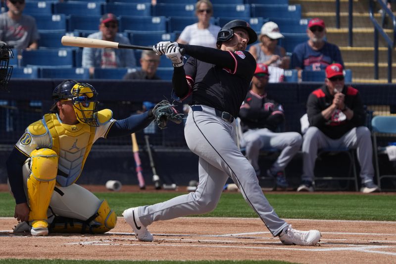 Mar 16, 2025; Phoenix, Arizona, USA; Cleveland Guardians shortstop Daniel Schneemann (10) hits against the Milwaukee Brewers in the first inning at American Family Fields of Phoenix. Mandatory Credit: Rick Scuteri-Imagn Images