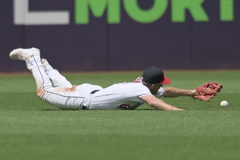 Jun 22, 2023; Cleveland, Ohio, USA; Cleveland Guardians center fielder Myles Straw (7) dives but can not catch a ball hit by Oakland Athletics pinch hitter Tyler Wade (not pictured) during the seventh inning at Progressive Field. Mandatory Credit: Ken Blaze-USA TODAY Sports