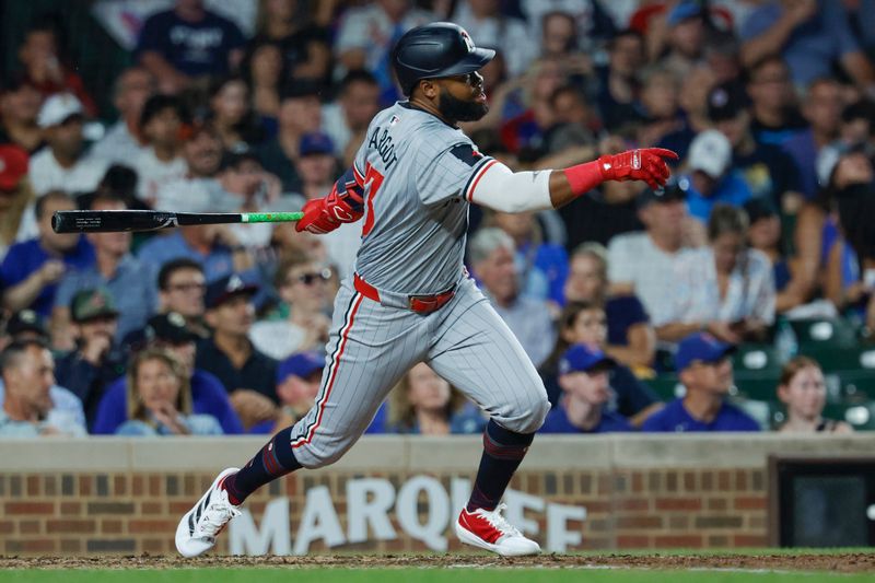 Aug 5, 2024; Chicago, Illinois, USA; Minnesota Twins outfielder Manuel Margot (13) hits a solo home run against the Chicago Cubs during the fifth inning at Wrigley Field. Mandatory Credit: Kamil Krzaczynski-USA TODAY Sports