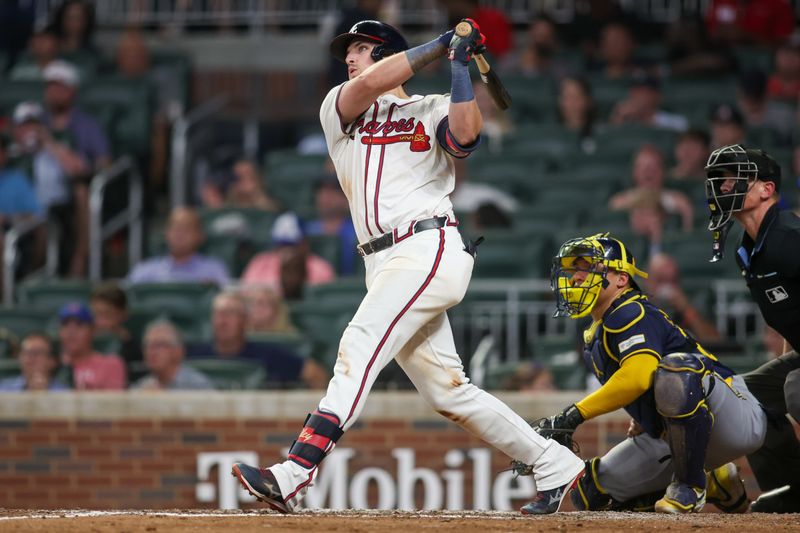 Aug 7, 2024; Atlanta, Georgia, USA; Atlanta Braves third baseman Austin Riley (27) hits a two-run home run against the Milwaukee Brewers in the fifth inning at Truist Park. Mandatory Credit: Brett Davis-USA TODAY Sports

