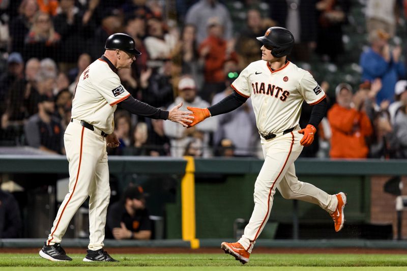 Sep 11, 2024; San Francisco, California, USA; San Francisco Giants third baseman Matt Chapman (26) is congratulated by third base coach Matt Williams (9) after he hit a solo home run against the Milwaukee Brewers during the fourth inning at Oracle Park. Mandatory Credit: John Hefti-Imagn Images