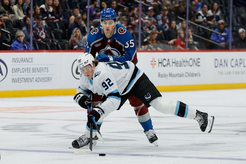Sep 21, 2025; Denver, Colorado, USA; Utah Mammoth center Logan Cooley (92) battles for the puck with Colorado Avalanche center Maros Jedlicka (55) in the first period at Ball Arena. Mandatory Credit: Isaiah J. Downing-Imagn Images