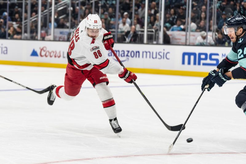 Oct 17, 2022; Seattle, Washington, USA; Carolina Hurricanes forward Martin Necas (88) takes a shot against Seattle Kraken defenseman Jamie Oleksiak (24) during the first period at Climate Pledge Arena. Mandatory Credit: Stephen Brashear-USA TODAY Sports