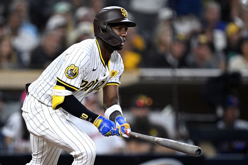 Aug 22, 2024; San Diego, California, USA; San Diego Padres left fielder Jurickson Profar (10) hits an RBI single against the New York Mets during the ninth inning at Petco Park. Mandatory Credit: Orlando Ramirez-USA TODAY Sports