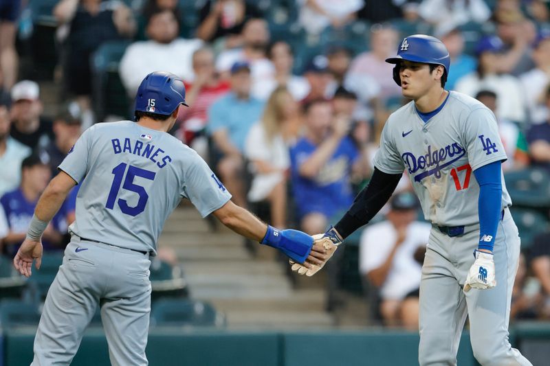 Jun 26, 2024; Chicago, Illinois, USA; Los Angeles Dodgers catcher Austin Barnes (15) and designated hitter Shohei Ohtani (17) celebrate after scoring against the Chicago White Sox during the third inning at Guaranteed Rate Field. Mandatory Credit: Kamil Krzaczynski-USA TODAY Sports