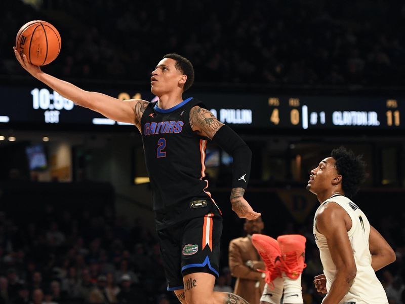 Mar 9, 2024; Nashville, Tennessee, USA; Florida Gators guard Riley Kugel (2) scores against Vanderbilt Commodores guard Ezra Manjon (5) during the first half at Memorial Gymnasium. Mandatory Credit: Christopher Hanewinckel-USA TODAY Sports