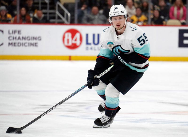 Jan 15, 2024; Pittsburgh, Pennsylvania, USA; Seattle Kraken right wing Kailer Yamamoto (56) skates up ice with the puck against the Pittsburgh Penguins during the second period at PPG Paints Arena. Mandatory Credit: Charles LeClaire-USA TODAY Sports