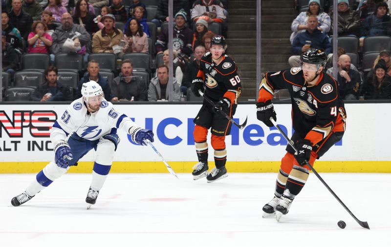 Mar 24, 2024; Anaheim, California, USA; Anaheim Ducks defenseman Cam Fowler (4) passes against Tampa Bay Lightning left wing Austin Watson (51) during the first period at Honda Center. Mandatory Credit: Jason Parkhurst-USA TODAY Sports