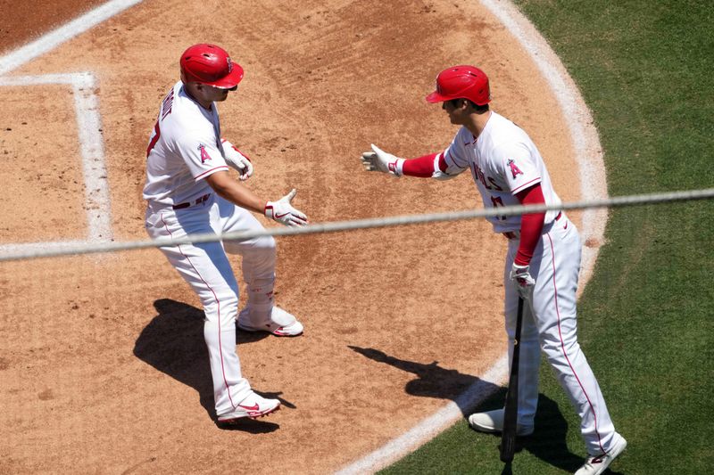 Jul 2, 2023; Anaheim, California, USA; Los Angeles Angels center fielder Mike Trout (27) celebrates with starting pitcher Shohei Ohtani (17) after hitting a solo home run in the first inning against the Arizona Diamondbacks at Angel Stadium. Mandatory Credit: Kirby Lee-USA TODAY Sports