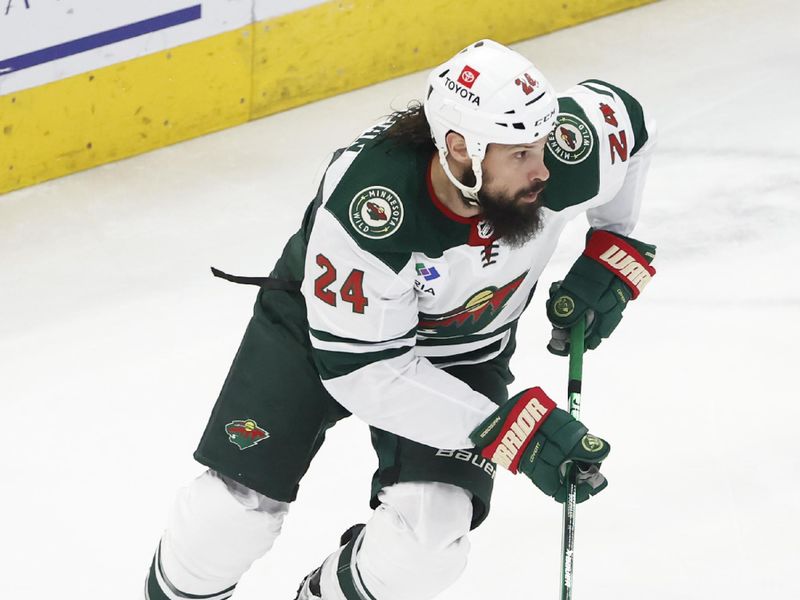 Feb 7, 2024; Chicago, Illinois, USA; Minnesota Wild defenseman Zach Bogosian (24) controls the puck against the Chicago Blackhawks during the first period at United Center. Mandatory Credit: Kamil Krzaczynski-USA TODAY Sports