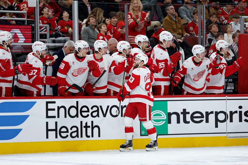 Dec 13, 2025; Chicago, Illinois, USA; Detroit Red Wings right wing Alex Debrincat (93) celebrates with teammates after scoring against the Chicago Blackhawks during the first period at United Center. Mandatory Credit: Kamil Krzaczynski-Imagn Images