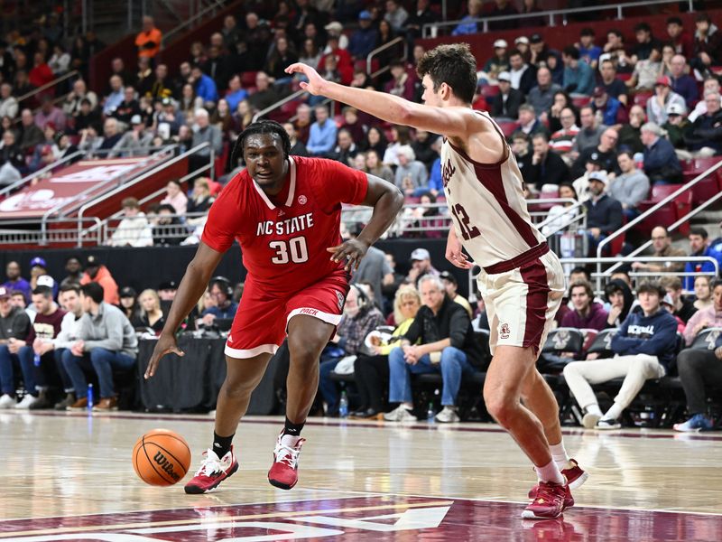 Feb 11, 2023; Chestnut Hill, Massachusetts, USA; North Carolina State Wolfpack forward D.J. Burns Jr. (30) drives to the basket against Boston College Eagles forward Quinten Post (12) during the second half at the Conte Forum. Mandatory Credit: Brian Fluharty-USA TODAY Sports