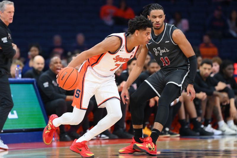 Dec 11, 2025; Syracuse, New York, USA; Syracuse Orange guard Kiyan Anthony (7) drives against Saint Joseph's Hawks guard Jaiden Glover-Toscano (11) during the first half at the JMA Wireless Dome. Mandatory Credit: Rich Barnes-Imagn Images