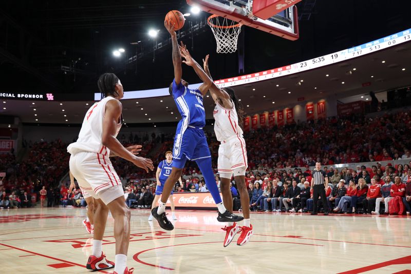 Dec 29, 2025; Houston, Texas, USA; Middle Tennessee Blue Raiders forward Torey Alston (10) shoots the ball as Houston Cougars forward Joseph Tugler (11) defends during the first half at Fertitta Center. Mandatory Credit: Troy Taormina-Imagn Images
