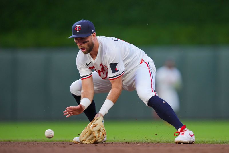 Jun 25, 2025; Minneapolis, Minnesota, USA; Minnesota Twins second base Kody Clemens (18) fields a ground ball against the Seattle Mariners in the sixth inning at Target Field. Mandatory Credit: Brad Rempel-Imagn Images