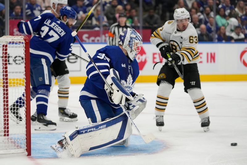 Apr 24, 2024; Toronto, Ontario, CAN; Boston Bruins forward Brad Marchand (63) tries to tip a shot on Toronto Maple Leafs goaltender Ilya Samsonov (35) during the second period of game three of the first round of the 2024 Stanley Cup Playoffs at Scotiabank Arena. Mandatory Credit: John E. Sokolowski-USA TODAY Sports