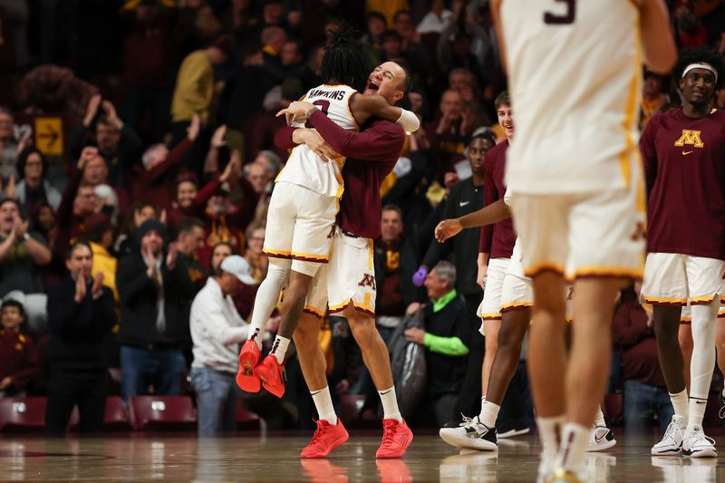 Jan 7, 2024; Minneapolis, Minnesota, USA; Minnesota Golden Gophers guard Elijah Hawkins (0) and forward Kris Keinys (8) celebrate the win against the Maryland Terrapins after the game at Williams Arena. Mandatory Credit: Matt Krohn-USA TODAY Sports