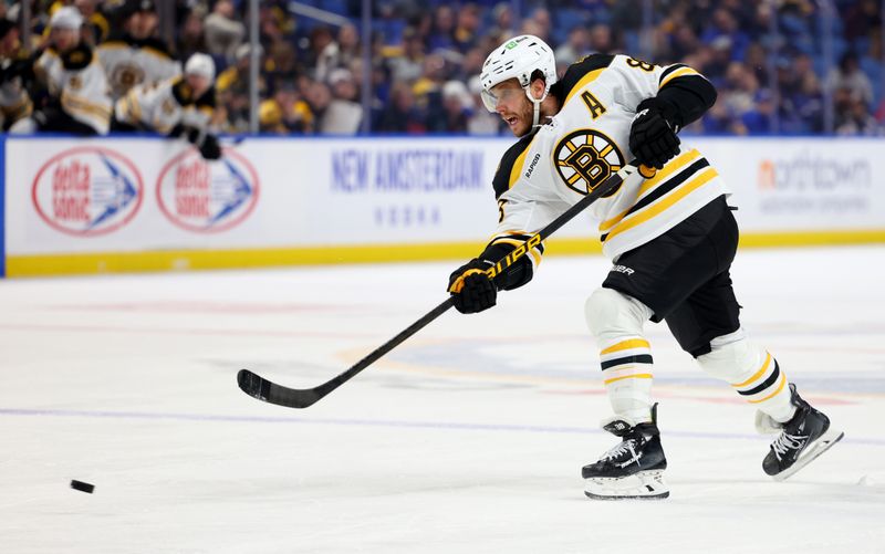 Apr 6, 2025; Buffalo, New York, USA;  Boston Bruins right wing David Pastrnak (88) takes a shot on goal during the third period against the Buffalo Sabres at KeyBank Center. Mandatory Credit: Timothy T. Ludwig-Imagn Images