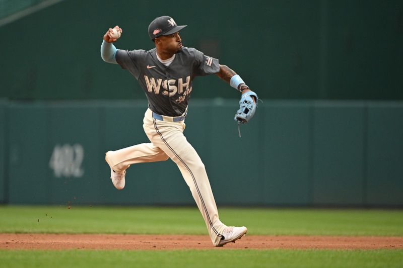 Sep 29, 2024; Washington, District of Columbia, USA; Washington Nationals shortstop Nasim Nunez (26) attempts a throw to first base after fielding a ground ball against the Philadelphia Phillies during the third inning at Nationals Park. Mandatory Credit: Rafael Suanes-Imagn Images