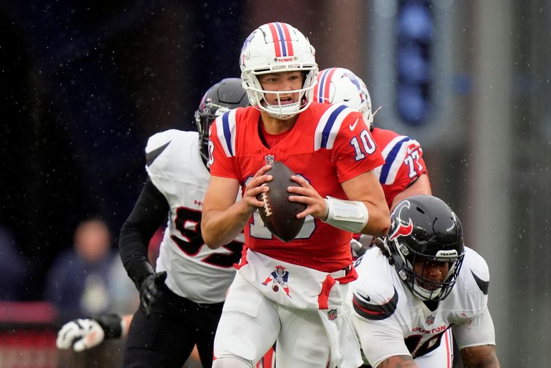 New England Patriots quarterback Drake Maye carries the ball during the second half of an NFL football game against the Houston Texans, Sunday, Oct. 13, 2024, in Foxborough, Mass. (AP Photo/Steven Senne)