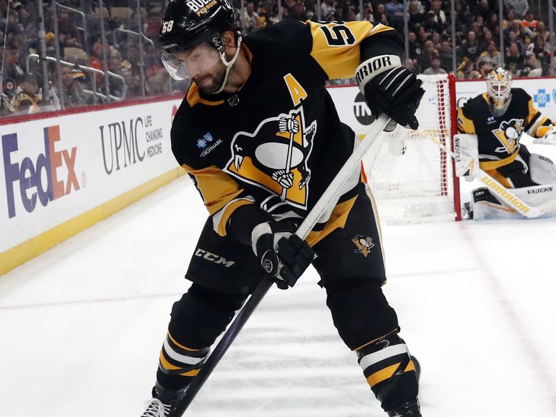 Feb 25, 2024; Pittsburgh, Pennsylvania, USA;  Pittsburgh Penguins defenseman Kris Letang (58) moves the puck against the Philadelphia Flyers during the third period at PPG Paints Arena. Pittsburgh won 7-6. Mandatory Credit: Charles LeClaire-USA TODAY Sports