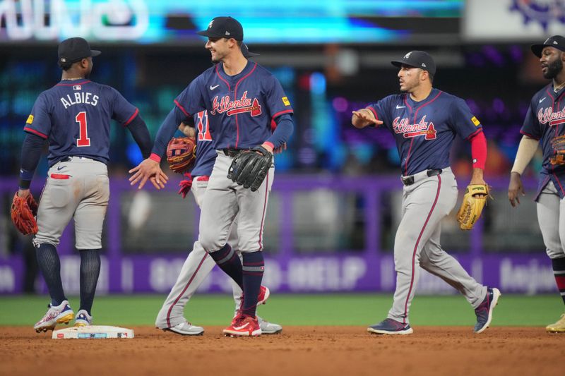 Sep 22, 2024; Miami, Florida, USA;  The Atlanta Braves celebrate a victory over the Miami Marlins at loanDepot Park. Mandatory Credit: Jim Rassol-Imagn Images