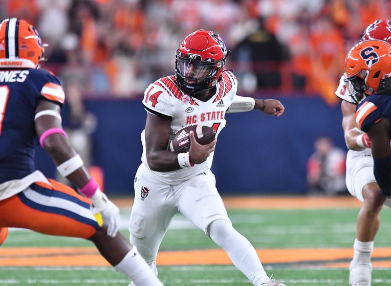 Oct 15, 2022; Syracuse, New York, USA; North Carolina State Wolfpack quarterback Jack Chambers (14) runs out of the pocket in the third quarter against the Syracuse Orange at JMA Wireless Dome. Mandatory Credit: Mark Konezny-USA TODAY Sports