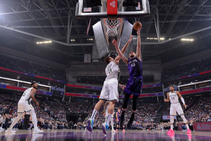 SACRAMENTO, CA - MARCH 12: Domantas Sabonis #10 of the Sacramento Kings drives to the basket during the game against the Milwaukee Bucks on March 12, 2024 at Golden 1 Center in Sacramento, California. NOTE TO USER: User expressly acknowledges and agrees that, by downloading and or using this Photograph, user is consenting to the terms and conditions of the Getty Images License Agreement. Mandatory Copyright Notice: Copyright 2024 NBAE (Photo by Rocky Widner/NBAE via Getty Images)