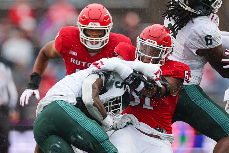 Oct 14, 2023; Piscataway, New Jersey, USA; Michigan State Spartans running back Nathan Carter (5) is tackled by Rutgers Scarlet Knights defensive lineman Troy Rainey (51) during the first half at SHI Stadium. Mandatory Credit: Vincent Carchietta-USA TODAY Sports