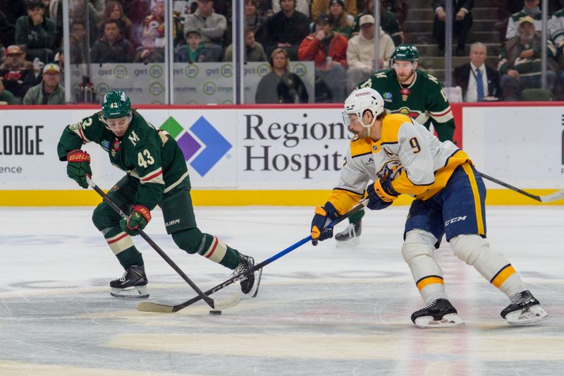 Dec 23, 2025; Saint Paul, Minnesota, USA; Minnesota Wild defenseman Quinn Hughes (43) and Nashville Predators left wing Filip Forsberg (9) play the puck in the first period at Grand Casino Arena. Mandatory Credit: Matt Blewett-Imagn Images