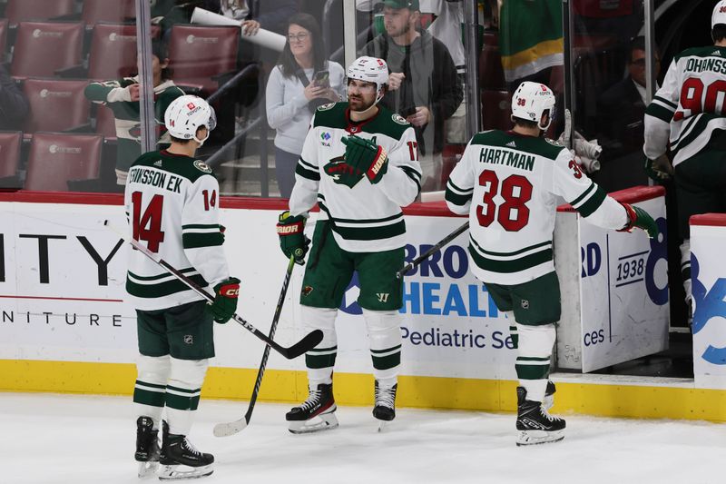 Jan 19, 2024; Sunrise, Florida, USA; Minnesota Wild left wing Marcus Foligno (17) celebrates with center Joel Eriksson Ek (14) after winning the game against the Florida Panthers during the third period at Amerant Bank Arena. Mandatory Credit: Sam Navarro-USA TODAY Sports