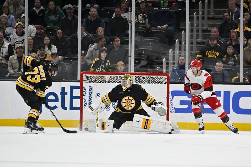 Nov 1, 2025; Boston, Massachusetts, USA; Boston Bruins goaltender Jeremy Swayman (1) makes a save while Carolina Hurricanes left wing Taylor Hall (71) watches and defenseman Charlie McAvoy (73) gathers the rebounding puck during the third period at TD Garden. Mandatory Credit: Eric Canha-Imagn Images