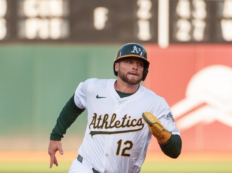 Jun 18, 2024; Oakland, California, USA; Oakland Athletics shortstop Max Schuemann (12) runs to third base during the third inning against the Kansas City Royals at Oakland-Alameda County Coliseum. Mandatory Credit: Ed Szczepanski-USA TODAY Sports