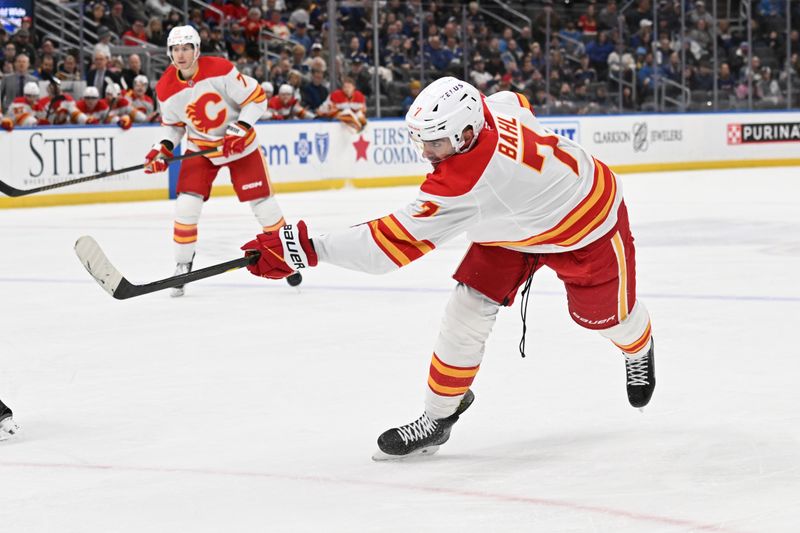 Jan 14, 2025; St. Louis, Missouri, USA; Calgary Flames defenseman Kevin Bahl (7) takes a shot against the St. Louis Blues in the first period at Enterprise Center. Mandatory Credit: Joe Puetz-Imagn Images