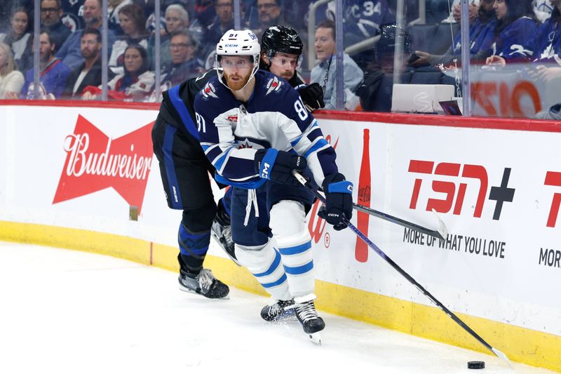 Oct 28, 2024; Winnipeg, Manitoba, CAN;  Winnipeg Jets forward Kyle Connor (81) skates away from Toronto Maple Leafs defensemen Simon Benoit (2) during the second period at Canada Life Centre. Mandatory Credit: Terrence Lee-Imagn Images