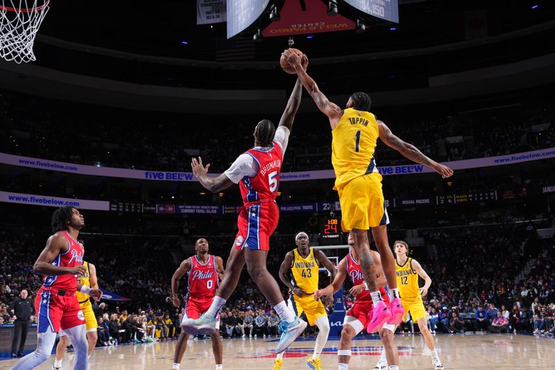 PHILADELPHIA, PA - DECEMBER 13: Andre Drummond #5 of the Philadelphia 76ers and Obi Toppin #1 of the Indiana Pacers go up for the rebound during the game on December 13, 2024 at the Wells Fargo Center in Philadelphia, Pennsylvania NOTE TO USER: User expressly acknowledges and agrees that, by downloading and/or using this Photograph, user is consenting to the terms and conditions of the Getty Images License Agreement. Mandatory Copyright Notice: Copyright 2024 NBAE (Photo by Jesse D. Garrabrant/NBAE via Getty Images)