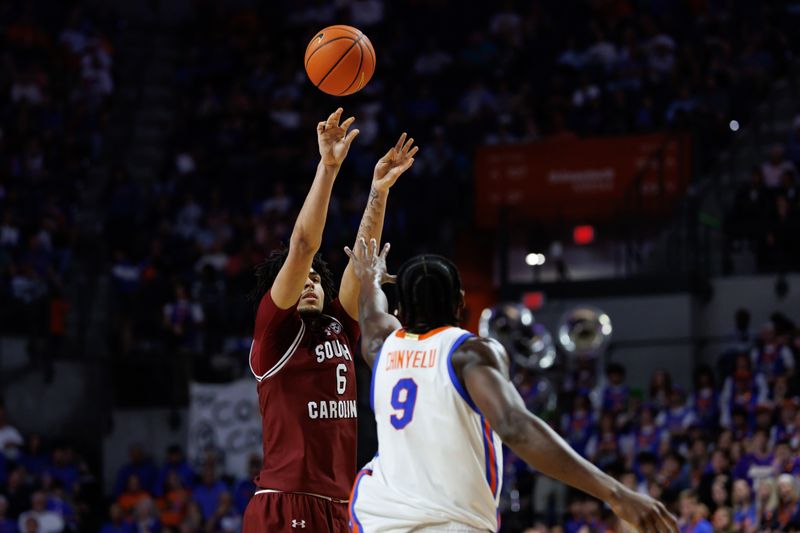 Feb 17, 2026; Gainesville, Florida, USA; South Carolina Gamecocks forward EJ Walker (6) shoots the ball over Florida Gators center Rueben Chinyelu (9) during the first half at Exactech Arena at the Stephen C. O'Connell Center. Mandatory Credit: Matt Pendleton-Imagn Images