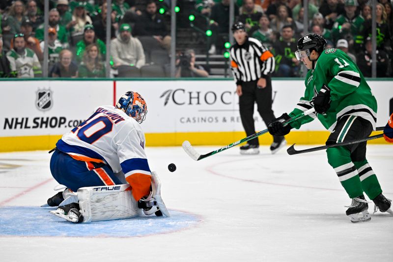 Oct 12, 2024; Dallas, Texas, USA; New York Islanders goaltender Semyon Varlamov (40) makes a glove save on a shot by Dallas Stars center Logan Stankoven (11) during the second period at the American Airlines Center. Mandatory Credit: Jerome Miron-Imagn Images