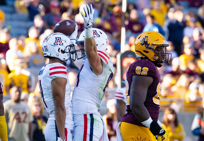 Nov 25, 2023; Tempe, Arizona, USA; Arizona Wildcats tight end Tanner McLachlan (right) celebrates a touchdown with wide receiver Tetairoa McMillan against the Arizona State Sun Devils in the second half of the Territorial Cup at Mountain America Stadium. Mandatory Credit: Mark J. Rebilas-USA TODAY Sports