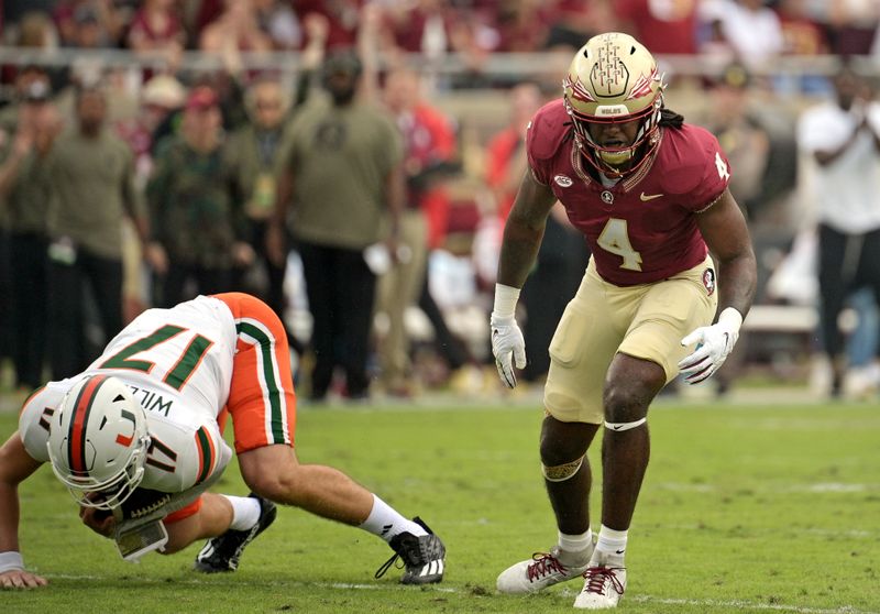 Nov 11, 2023; Tallahassee, Florida, USA; Florida State Seminoles linebacker Kalen Deloach (4) celebrates a sack against Miami Hurricanes quarterback Emory Williams (17) during the first quarter at Doak S. Campbell Stadium. Mandatory Credit: Melina Myers-USA TODAY Sports