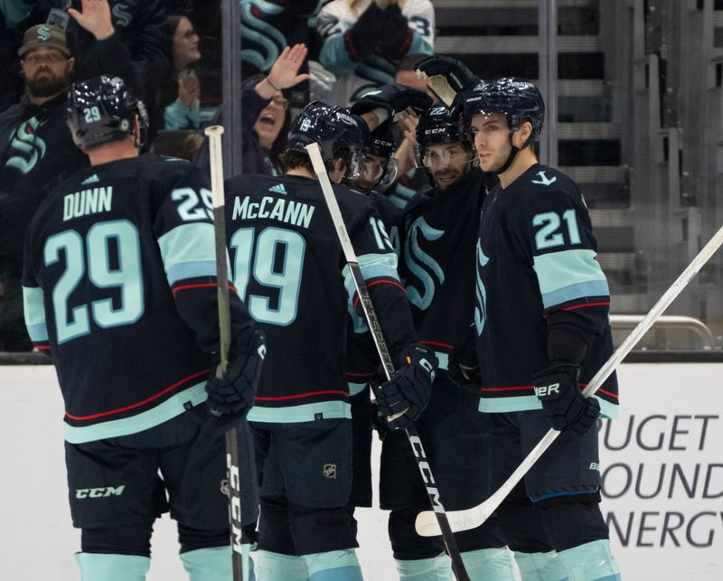 Jan 28, 2024; Seattle, Washington, USA; Seattle Kraken, from left, defenseman Vince Dunn (29), forward Jared McCann (19), forward Oliver Bjorkstrand (22) and forward Alex Wennberg (21) celebrate a power play goal during the first period against the Columbus Blue Jackets at Climate Pledge Arena. Mandatory Credit: Stephen Brashear-USA TODAY Sports