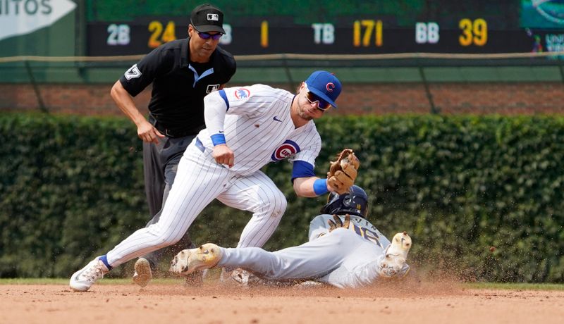 Jul 24, 2024; Chicago, Illinois, USA; Chicago Cubs second baseman Nico Hoerner (2) tags out Milwaukee Brewers outfielder Blake Perkins (16) at second base on a steal attempt during the fifth inning at Wrigley Field. Mandatory Credit: David Banks-USA TODAY Sports