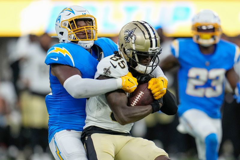 Los Angeles Chargers linebacker Mikel Jones (49) tackles New Orleans Saints wide receiver Jontre Kirklin (85) in the second half of an NFL football game in Inglewood, Calif., Sunday, Aug. 20, 2023. (AP Photo/Marcio Jose Sanchez)