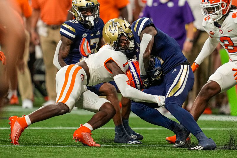 Sep 5, 2022; Atlanta, Georgia, USA; Georgia Tech Yellow Jackets running back Hassan Hall (3) is tackled by Clemson Tigers safety Andrew Mukuba (1) during the first quarter at Mercedes-Benz Stadium. Mandatory Credit: Dale Zanine-USA TODAY Sports