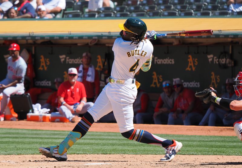 Jul 4, 2024; Oakland, California, USA; Oakland Athletics right fielder Lawrence Butler (4) hits a solo home run against the Los Angeles Angels during the eighth inning at Oakland-Alameda County Coliseum. Mandatory Credit: Kelley L Cox-USA TODAY Sports