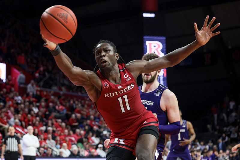 Mar 5, 2023; Piscataway, New Jersey, USA; Rutgers Scarlet Knights center Clifford Omoruyi (11) rebounds in front of Northwestern Wildcats forward Gus Hurlburt (54) during the second half at Jersey Mike's Arena. Mandatory Credit: Vincent Carchietta-USA TODAY Sports