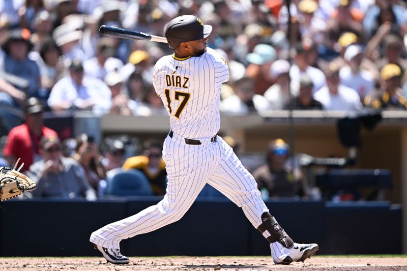 Apr 30, 2025; San Diego, California, USA; San Diego Padres catcher Elias Diaz (17) hits a solo home run during the third inning against the San Francisco Giants at Petco Park. Adames was out on the play. Mandatory Credit: Denis Poroy-Imagn Images